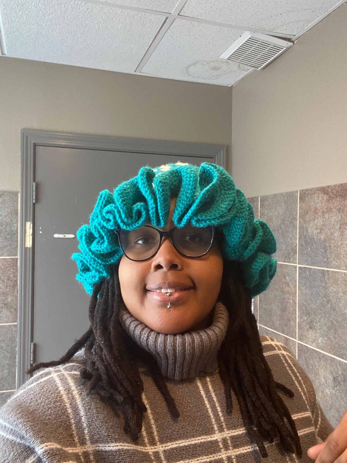 Crocheted Granny square hat with ruffled rim