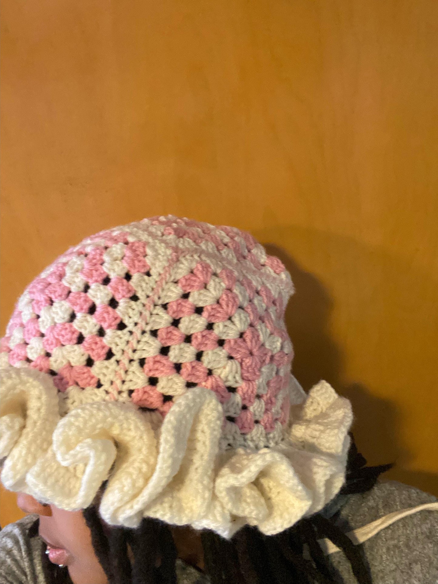 Crocheted Granny square hat with ruffled rim