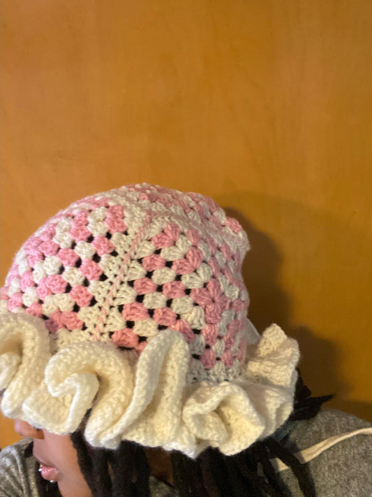 Crocheted Granny square hat with ruffled rim